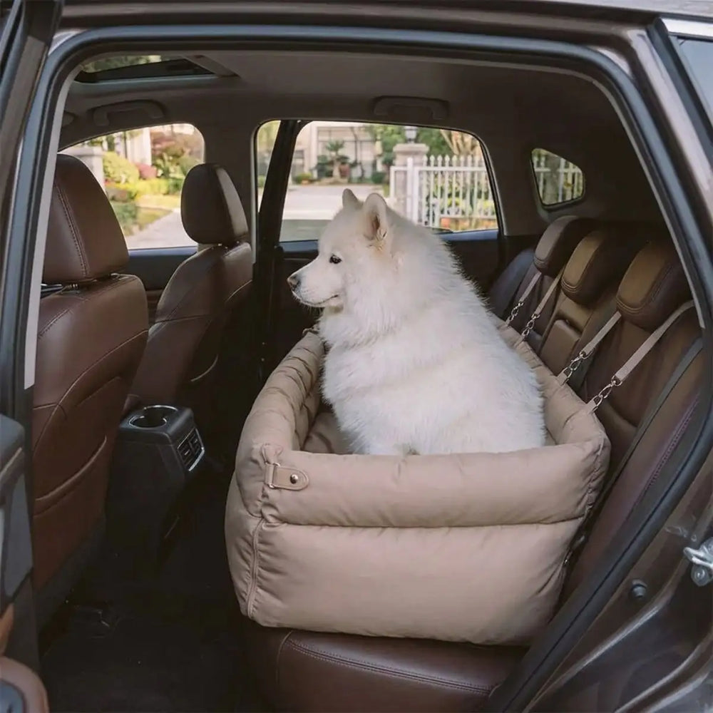 Dog settled in a KovePaws CalmRide car bed with bolster sides